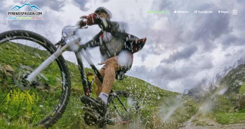 a man is riding a bike on a hill at Hotel Restaurant Les Brases in Sort