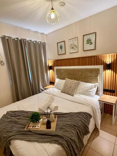 a bedroom with a large bed with a tray on it at 8 Spatial Condo in Davao City