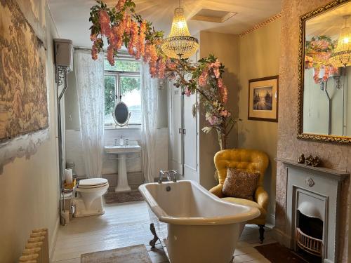 a bathroom with a tub and a toilet and a sink at Liberty House in Ashbourne