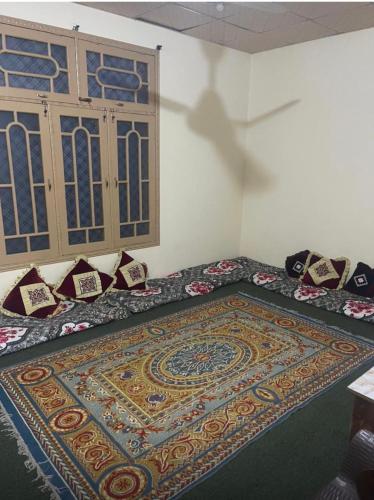 a room with a bed with a rug on the floor at Village Homestay in Chalt