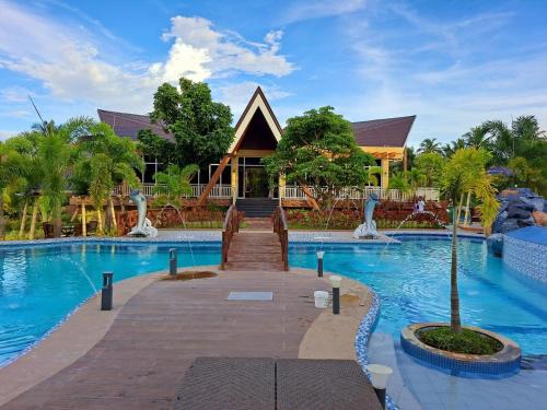 a resort with a swimming pool and a building at Gamboa's Orchard Malilipot Albay in Malilipot