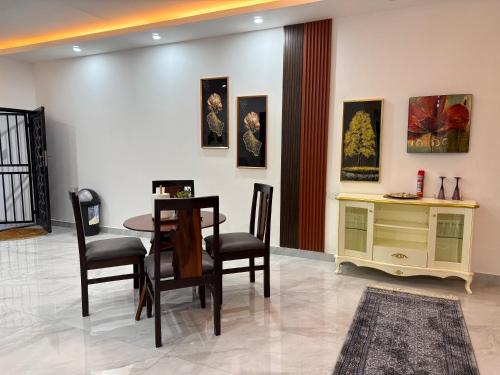 a dining room with a table and chairs at Samash villas 2 in Lusaka