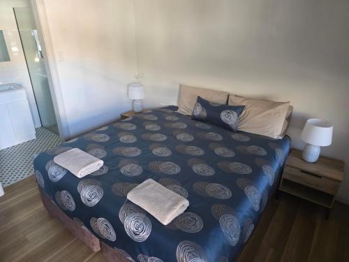 a bedroom with a bed with towels on it at Heritage City Motor Inn in Broken Hill