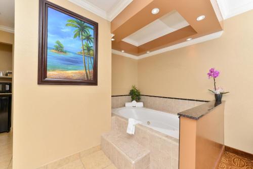 a bathroom with a bath tub and a window at Rodeway Inn San Diego Near SDSU in San Diego