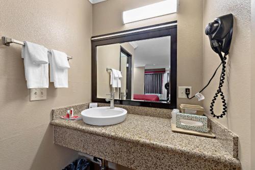 a bathroom with a sink and a mirror at Econo Lodge Inn & Suites Escondido Downtown in Escondido