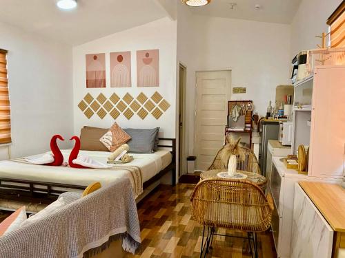 a living room with a bed and a chair in it at Olango Island-Tiny Guest House Fully Furnished with Hot Shower, Washer, Wi-Fi, Netflix & King Bed S&E-3 in Lapu Lapu City