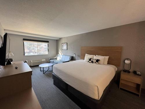 a hotel room with a bed and a chair at Comfort Inn & Suites Golden - Denver West in Golden