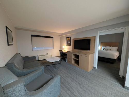 a hotel room with a couch and a tv and a bed at Comfort Inn & Suites Golden - Denver West in Golden