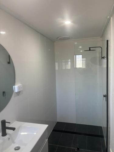 a bathroom with a shower and a sink at Heritage City Motor Inn in Broken Hill