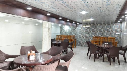 a restaurant with tables and chairs in a room at Corbett Hill Site in Rāmnagar
