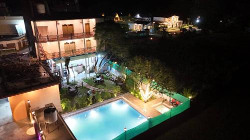 an overhead view of a swimming pool at night at Corbett Hill Site in Rāmnagar