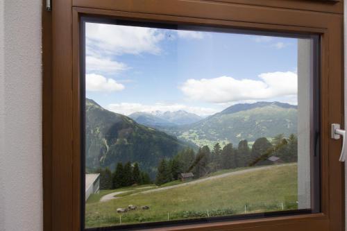 a window with a view of a mountain view at Berggasthof Hochzeigerhaus in Jerzens