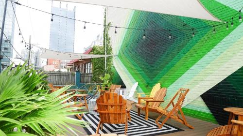 a patio with chairs and a colorful wall at The Sobro Guest House by AvantStay in Nashville
