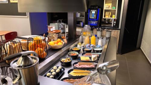 a buffet line with many different types of food at Campanile Marmande in Marmande