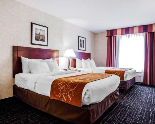 a hotel room with two beds and a window at Comfort Suites Independence - Kansas City in Independence