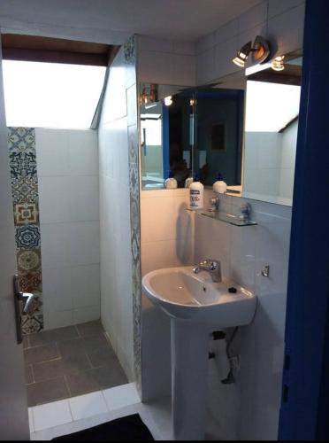 a bathroom with a sink and a mirror at Ellenas- studios Nikiana Lefkada in Nikiana