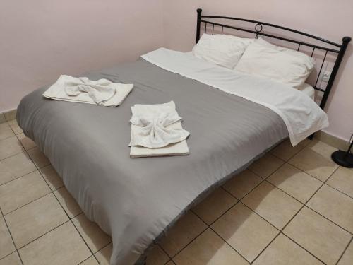 a bed with two towels on top of it at Nikolettas Studios Traditional House in Paradeísion