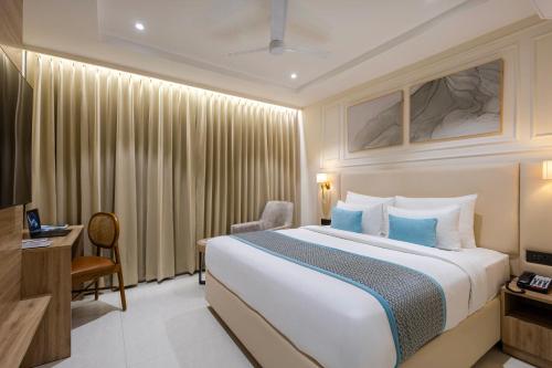 a hotel room with a bed and a desk at Monday Premium Madhapur in Hyderabad