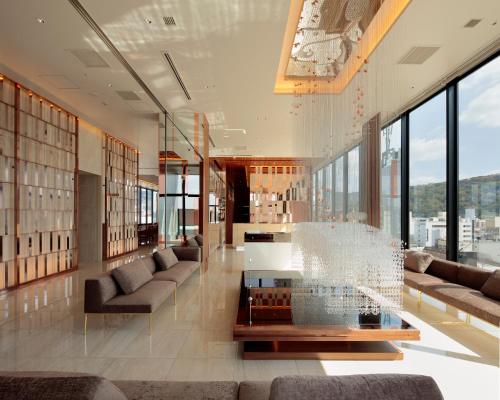 a lobby with couches and a table in a building at Candeo Hotels Nagasaki Shinchi Chinatown in Nagasaki