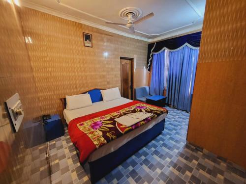 a bedroom with a bed in a room with a door at Pratap Resort in Katra
