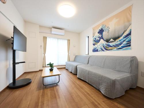 a living room with a couch and a tv at K-Stay TOKYO HANEDA in Tokyo