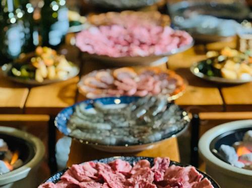 a table with many plates of food on it at Lagom Homestay in Yoshino