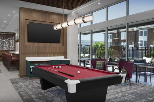 a living room with a pool table and a tv at Homewood Suites By Hilton Columbia Downtown in Columbia