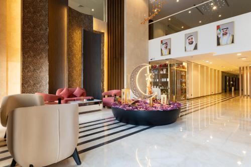 a lobby with chairs and a flower bowl in the middle at Reya Creek Hotel in Dubai
