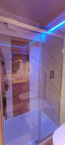 a shower with a glass door in a bathroom at Nina in Love in Salerno