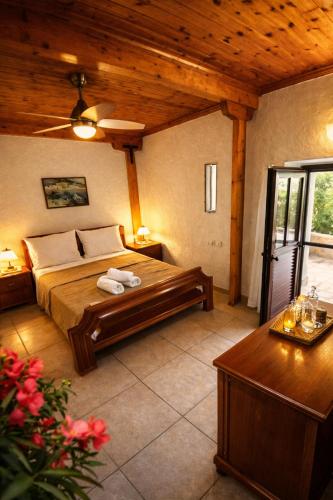 a bedroom with a bed and a wooden ceiling at Alma-Maroon Klara & Rachel in Drymon