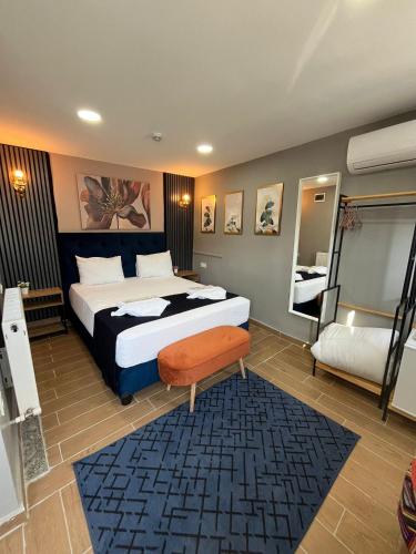 a bedroom with a large bed and a chair in it at Emirhan Guesthouse & Suites in Istanbul