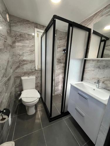a bathroom with a toilet and a shower and a sink at Emirhan Guesthouse & Suites in Istanbul