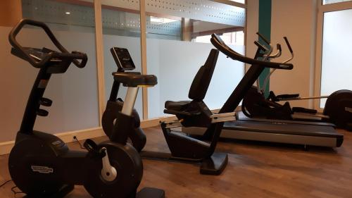 a gym with two exercise bikes in a room at Parkhotel Kevelaer in Kevelaer