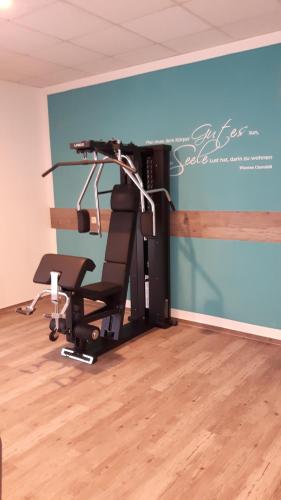 a gym with a chair in a room at Parkhotel Kevelaer in Kevelaer
