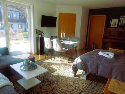 a living room with a bed and a table and a couch at TauberGenuss in Werbach