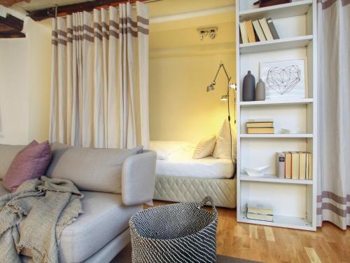 a living room with a couch and a book shelf at Apartments Constance in Konstanz