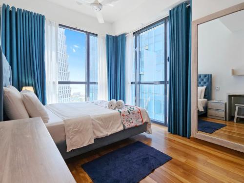 a bedroom with a bed and large windows at Evolve - Céleste in Colombo
