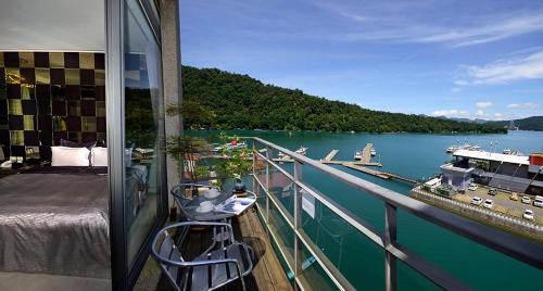 a balcony with a view of a boat on a lake at Lakeview Homestay in Yuchi