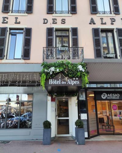 a store front of a building with plants on it at Hôtel des Alpes in Annecy