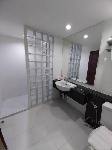 a bathroom with a sink and a mirror at Nana Hiso Hotel in Bangkok