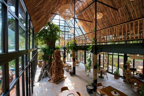 a large building with windows and plants in it at Luxcamp Selo - Merapi View by Horison in Selo