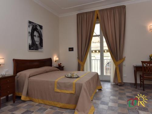 Ένα ή περισσότερα κρεβάτια σε δωμάτιο στο Dimora conte di Ruvo