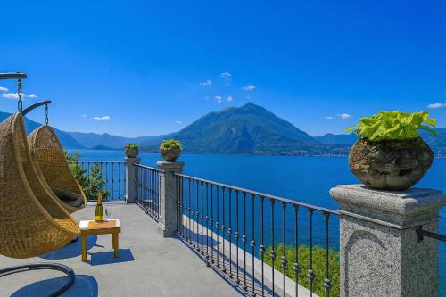 a balcony with a view of the water and mountains at Villa Lucia Varenna in Varenna