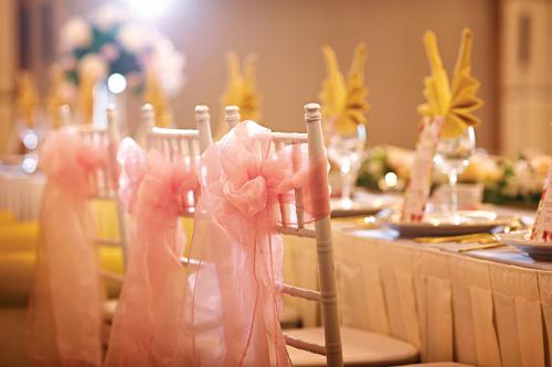 a table topped with chairs with pink napkins at Dorsett Putrajaya in Putrajaya
