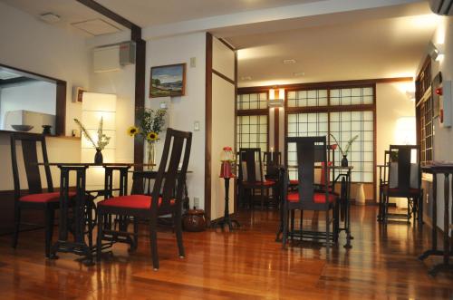 a dining room with a table and chairs in it at La Passione Boutique B&B in Naha