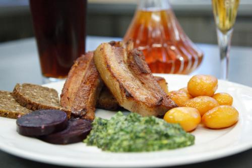 a plate of food with toast potatoes and other foods at Sevel Kro in Vinderup