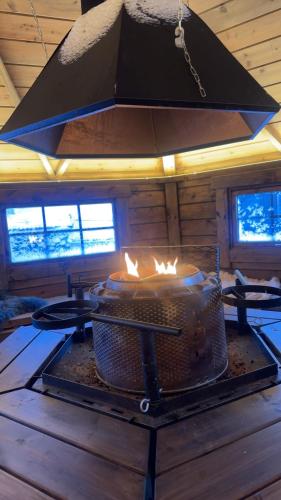 a stove in a log cabin with a fireplace at Home with a view in Storholmen