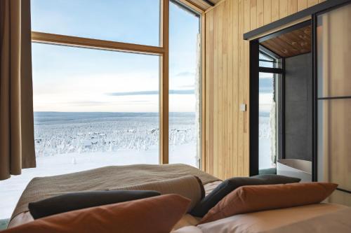 a bedroom with a bed and a large window at Star Arctic Hotel & Activities in Saariselka