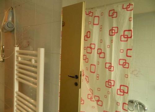 a bathroom with a shower curtain with letters on it at Bed And Roses in Montesilvano