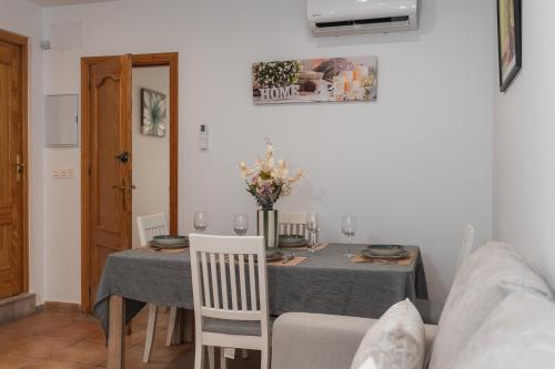 a dining room with a table with a gray table cloth at Casa del sol Armilla in Armilla